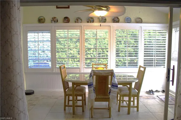 a dining room with furniture and window