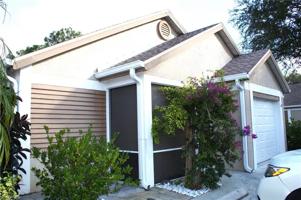 a view of a house with potted plants