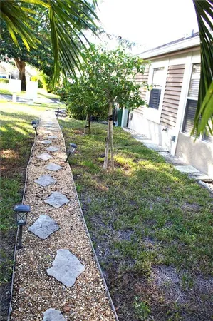 a backyard of a house with table and chairs