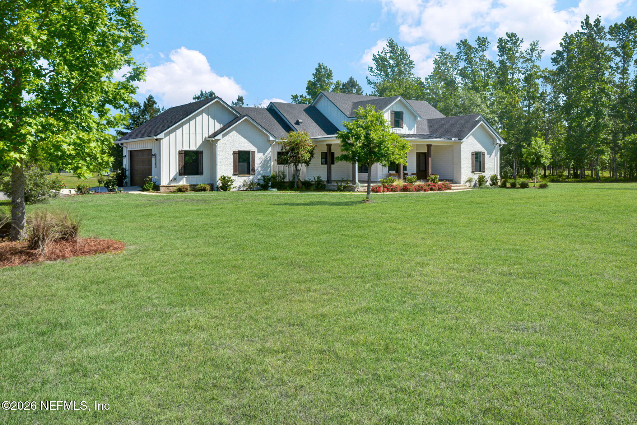 57353 Sandy Oaks Lane Callahan, FL 32011 - Photo 1 of 61 a front view of a house with a garden