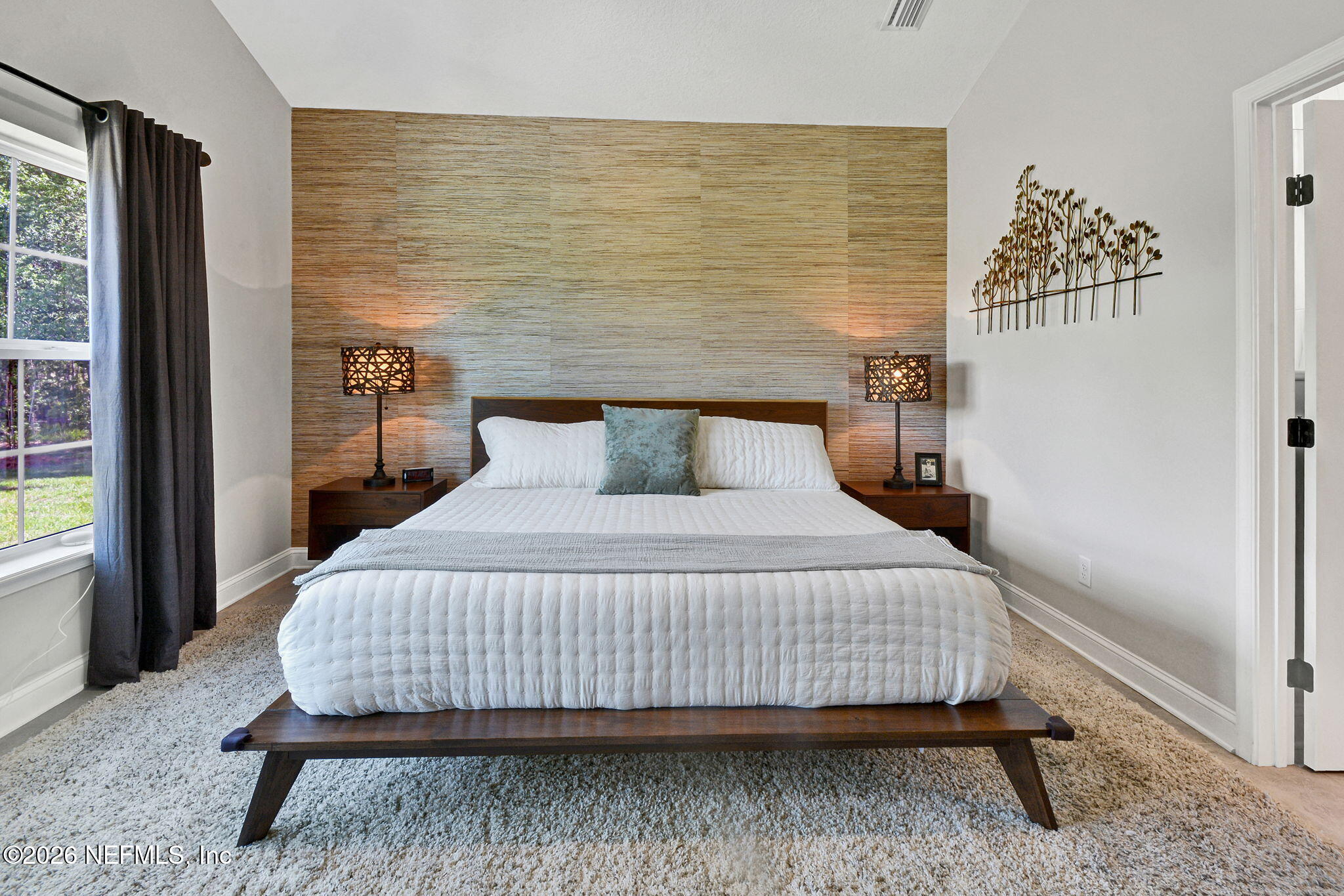 57353 Sandy Oaks Lane Callahan, FL 32011 - Photo 16 of 61 a bedroom with a bed and wooden floor