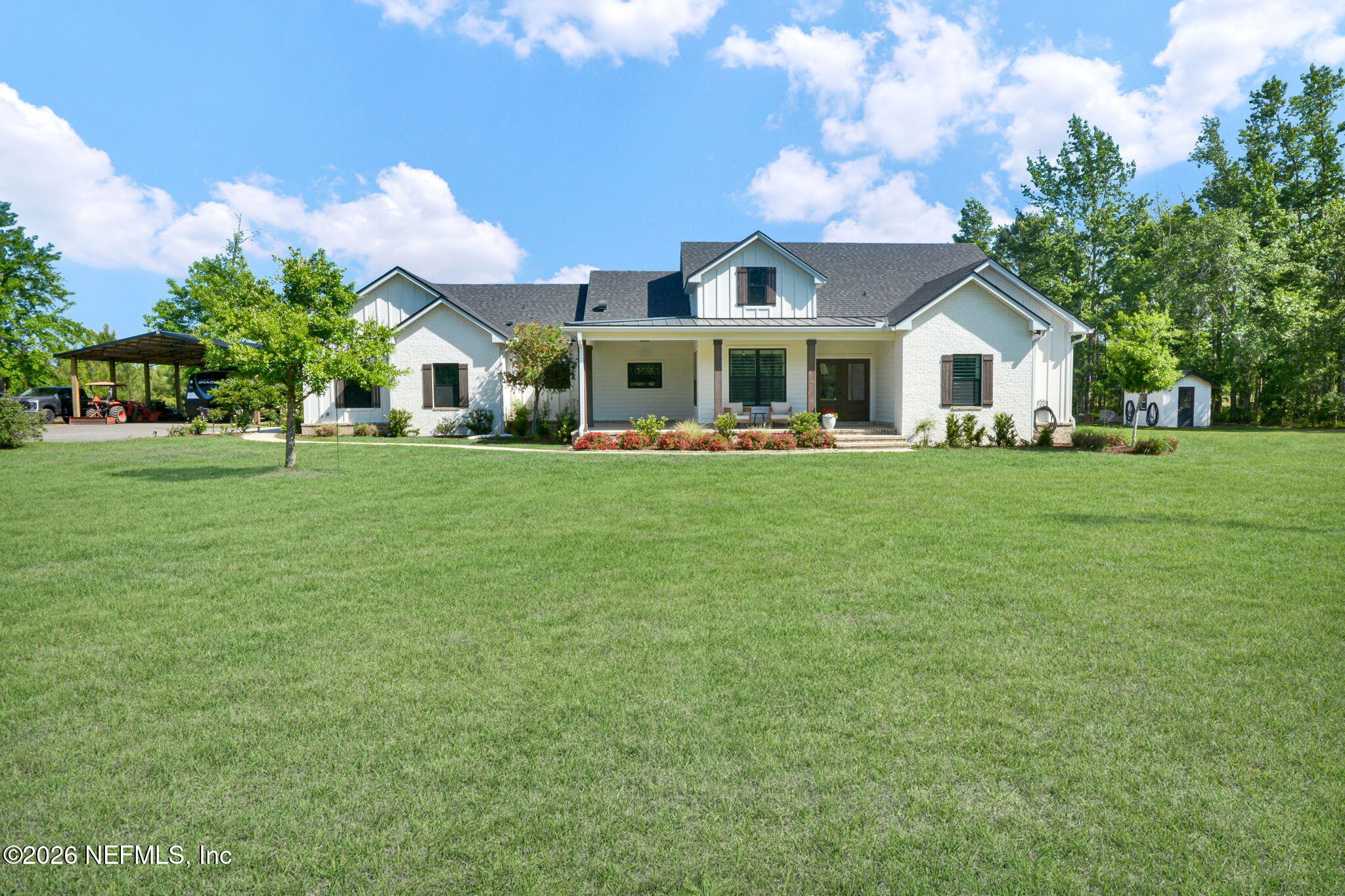 57353 Sandy Oaks Lane Callahan, FL 32011 - Photo 2 of 61 a front view of a house with a garden