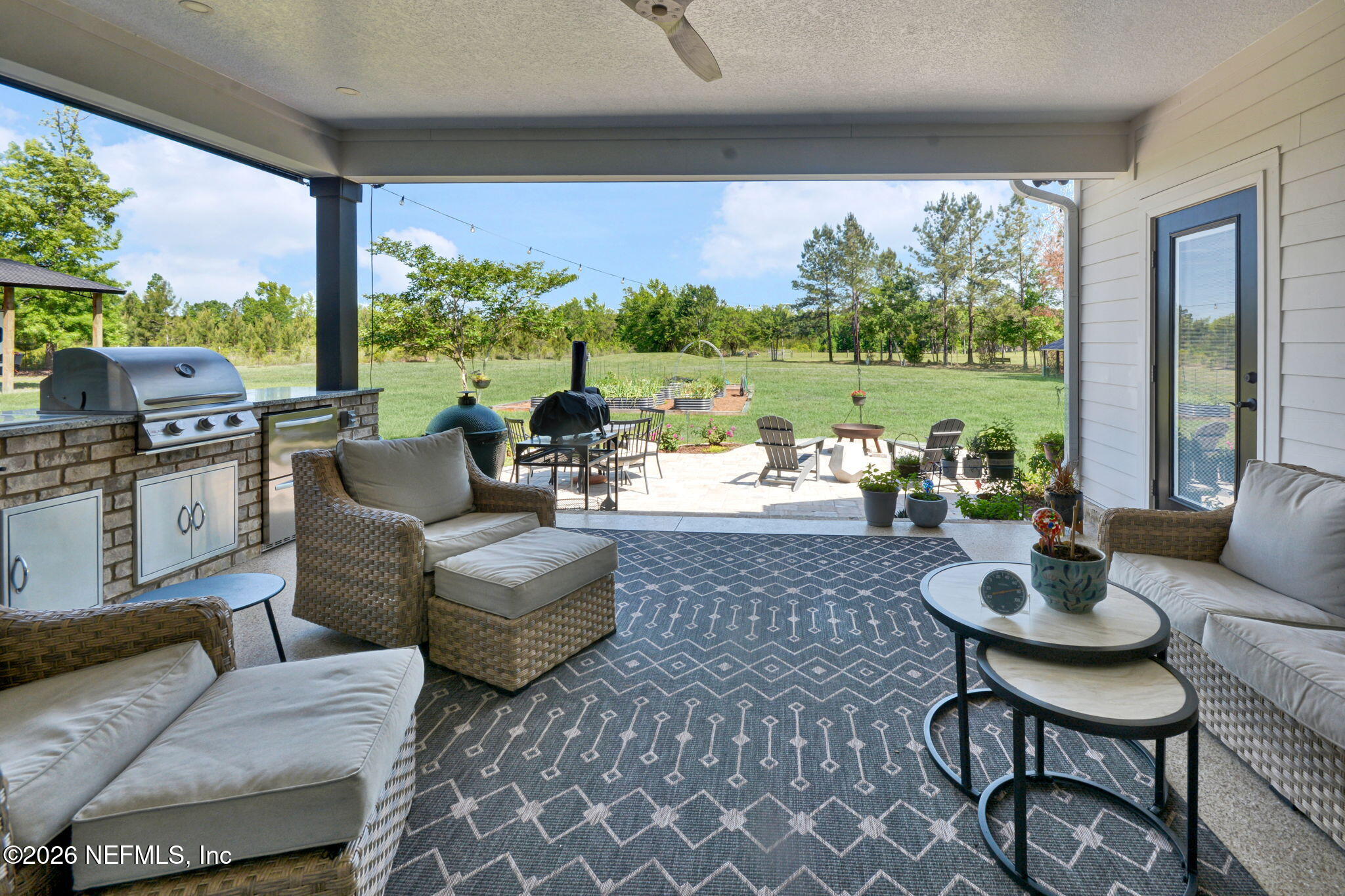 57353 Sandy Oaks Lane Callahan, FL 32011 - Photo 27 of 61 a living room with patio furniture and a floor to ceiling window