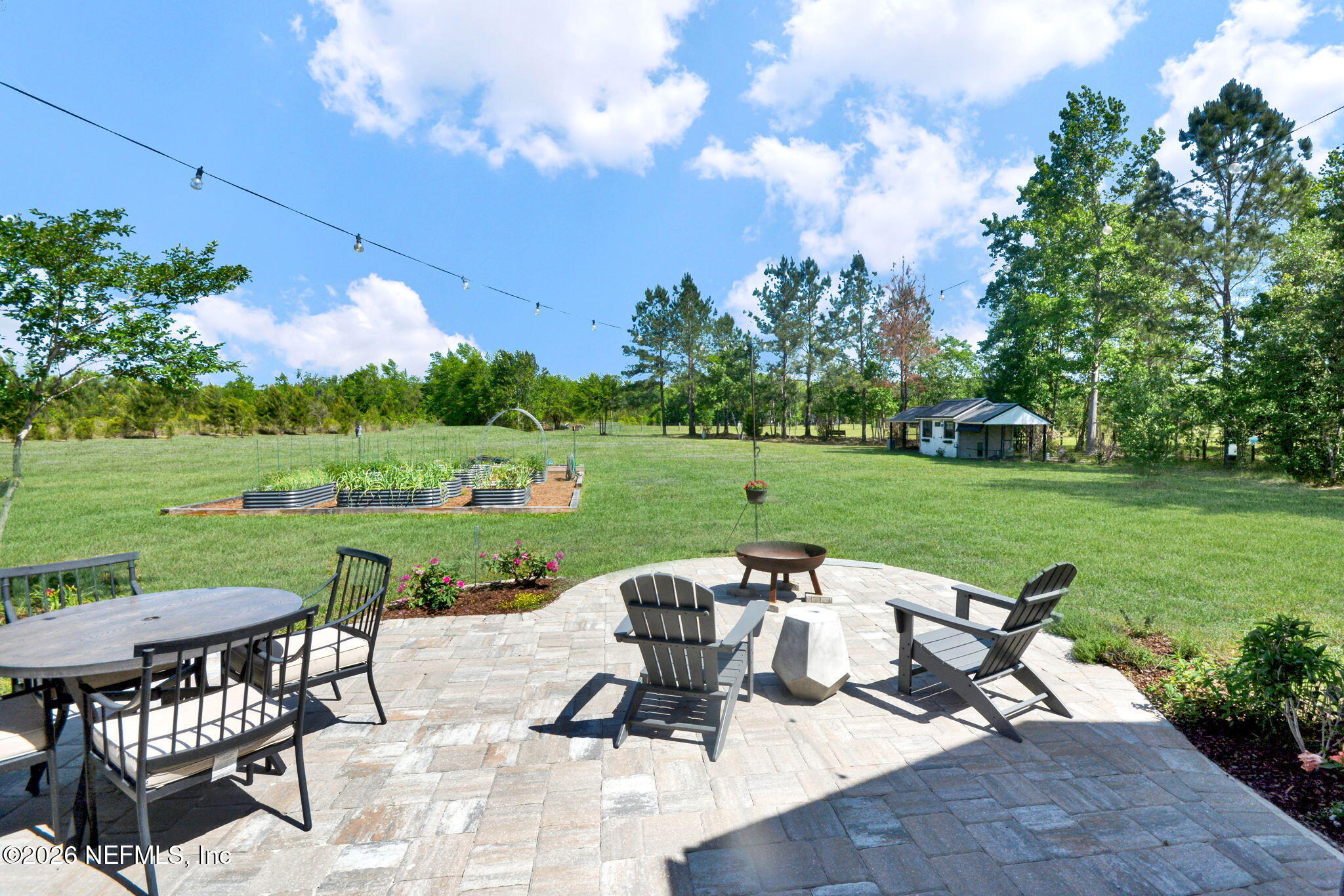 57353 Sandy Oaks Lane Callahan, FL 32011 - Photo 29 of 61 a view of a swimming pool and lounge chairs in back yard