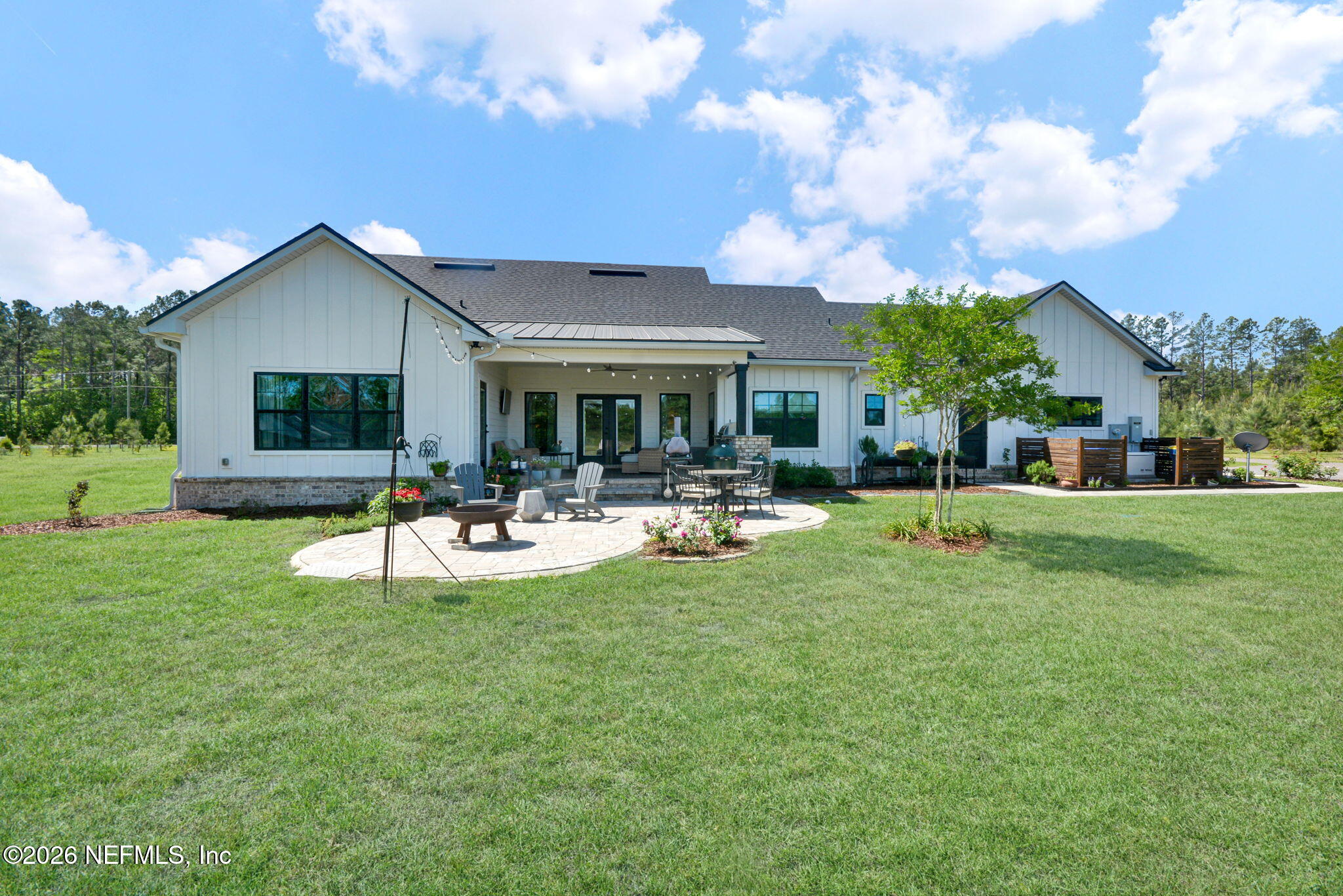 57353 Sandy Oaks Lane Callahan, FL 32011 - Photo 30 of 61 a view of a house with swimming pool and a garden
