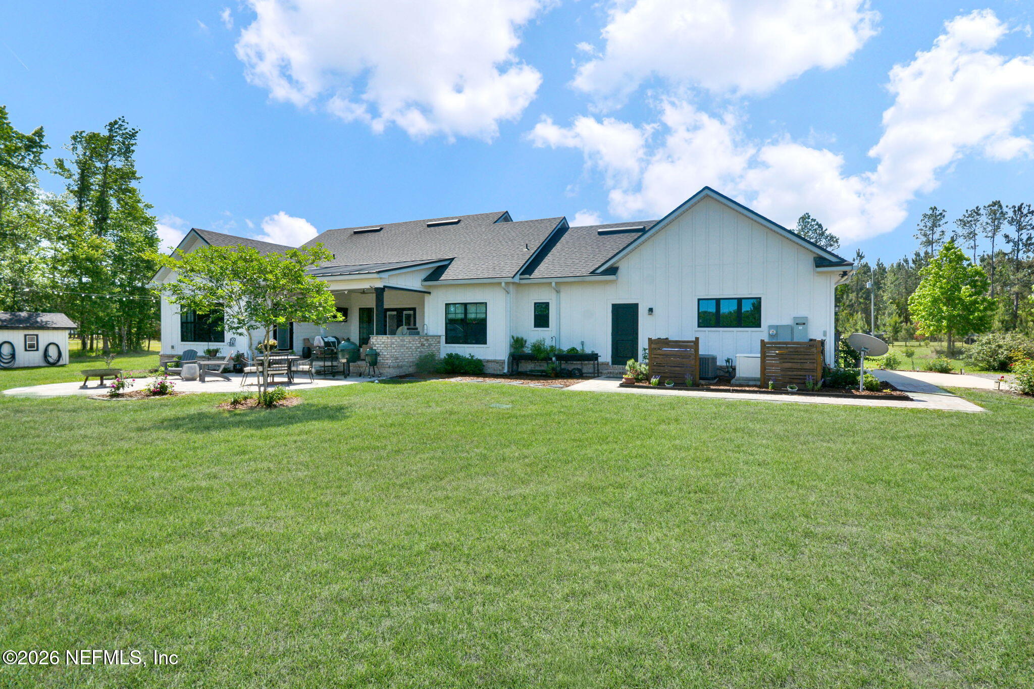 57353 Sandy Oaks Lane Callahan, FL 32011 - Photo 32 of 61 a swimming pool view with a seating space and a garden view