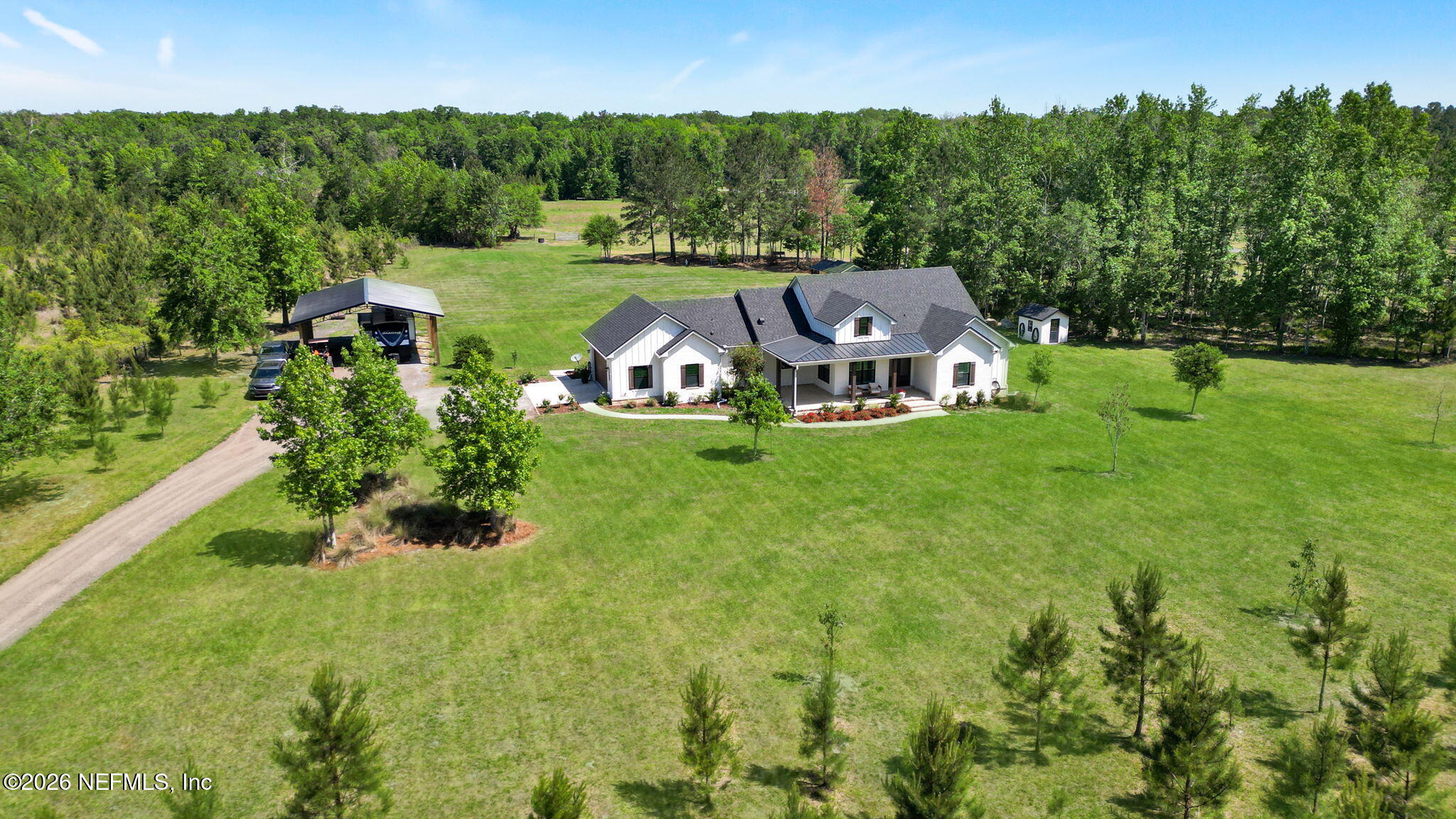 57353 Sandy Oaks Lane Callahan, FL 32011 - Photo 38 of 61 an aerial view of a house with yard and trees in the background