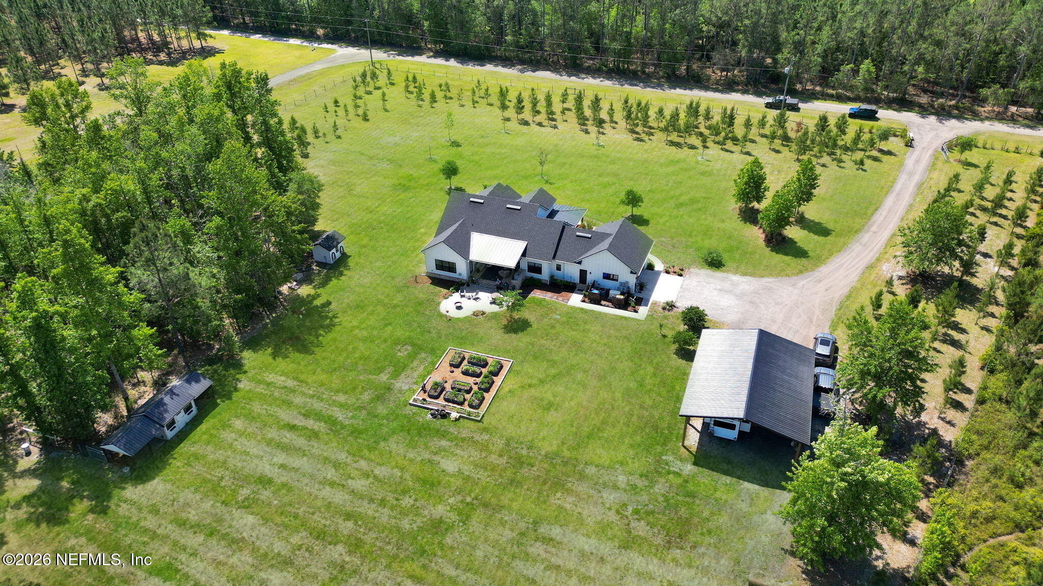57353 Sandy Oaks Lane Callahan, FL 32011 - Photo 45 of 61 an aerial view of a house with a garden and swimming pool