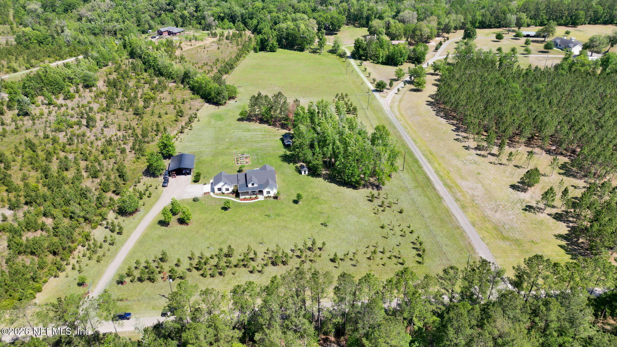 57353 Sandy Oaks Lane Callahan, FL 32011 - Photo 53 of 61 a view of a yard with plants and large trees