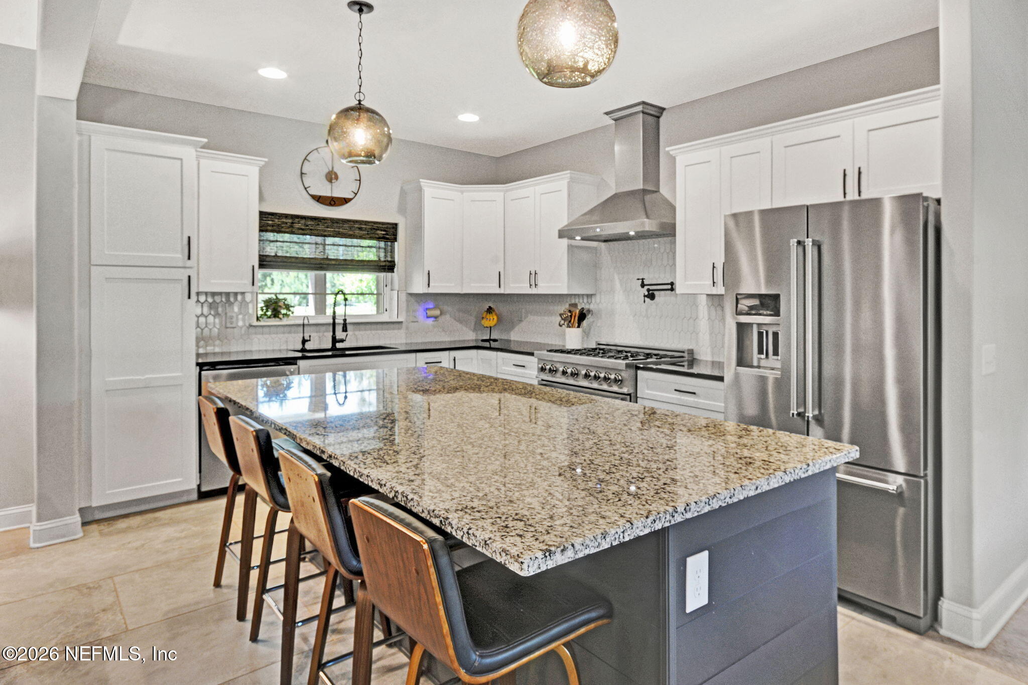 57353 Sandy Oaks Lane Callahan, FL 32011 - Photo 9 of 61 a kitchen with stainless steel appliances granite countertop a sink a refrigerator and a stove
