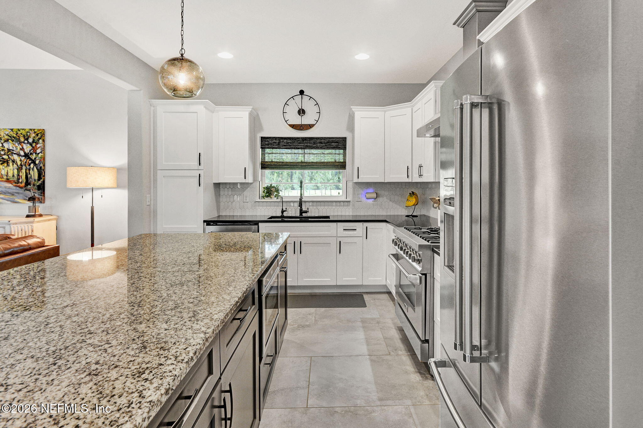 57353 Sandy Oaks Lane Callahan, FL 32011 - Photo 10 of 61 a kitchen with stainless steel appliances granite countertop a sink stove and refrigerator