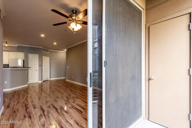 a view of kitchen and hallway with a ceiling fan