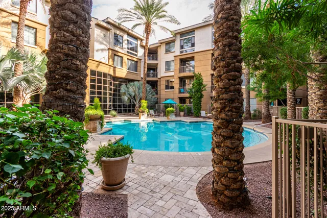 a view of a tall building with a potted plant and a fountain