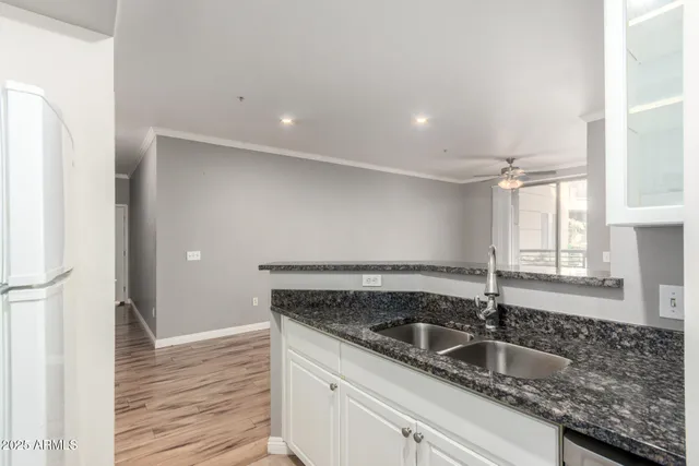 a kitchen with granite countertop a sink and a window