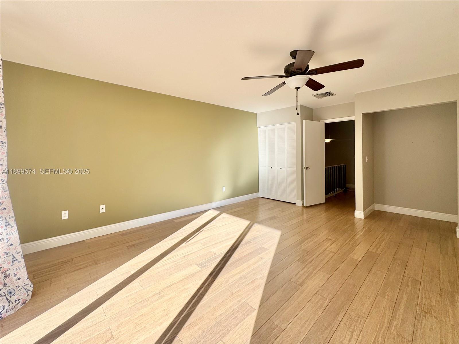 21643 Cypress Road, Unit 14D Boca Raton, FL 33433 - Photo 13 of 26 a view of a room with wooden floor and ceiling fan