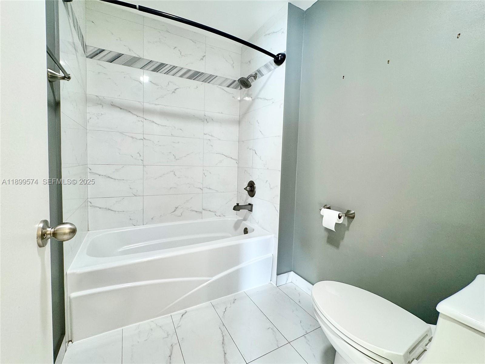 21643 Cypress Road, Unit 14D Boca Raton, FL 33433 - Photo 17 of 26 a bathroom with a toilet and a shower