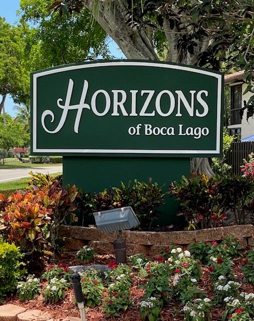 21643 Cypress Road, Unit 14D Boca Raton, FL 33433 - Photo 24 of 26 a sign broad in front of flowers
