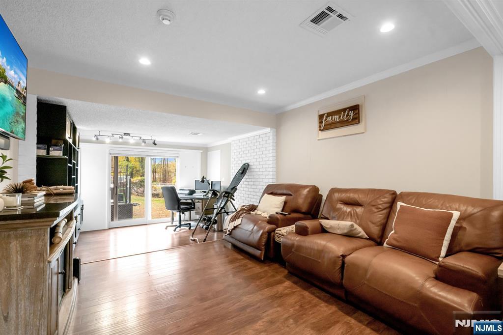 205 Davis Avenue Hackensack, NJ 07601 - Photo 14 of 47 a living room with furniture and a flat screen tv