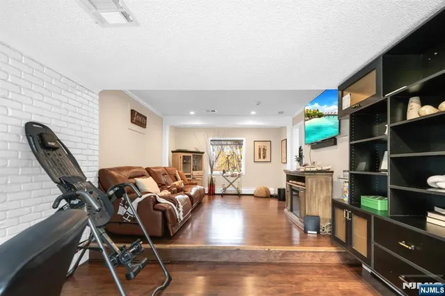 a living room with furniture a air conditioner and a window