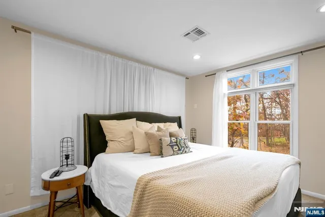 a bedroom with a large bed and a window