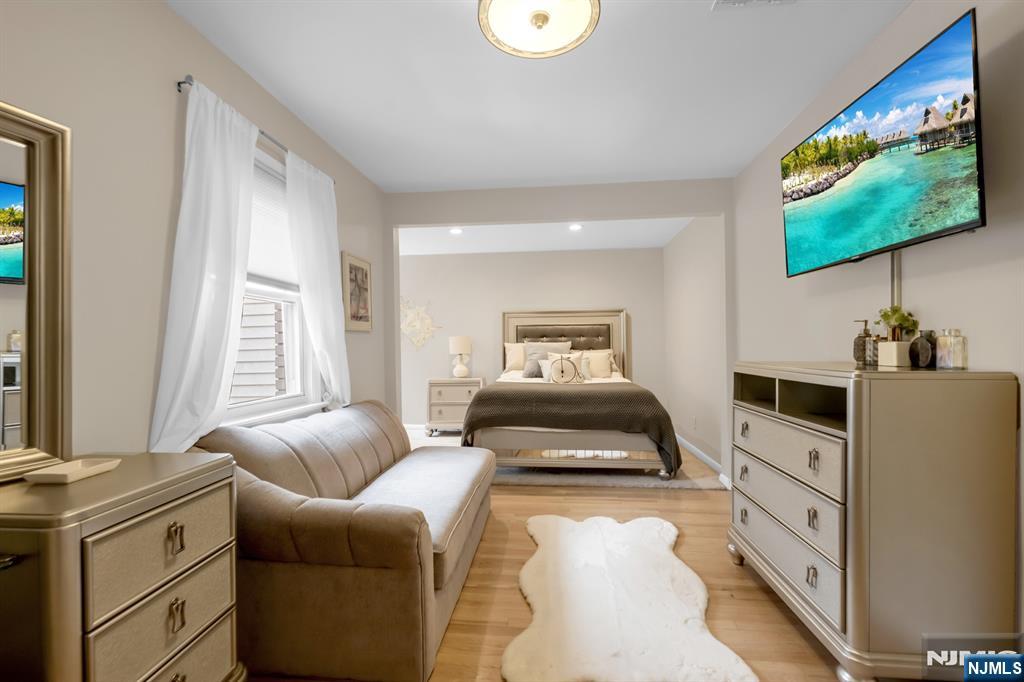 205 Davis Avenue Hackensack, NJ 07601 - Photo 31 of 47 a bedroom with furniture and a flat screen tv