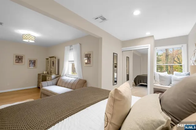 a bedroom with a bed and glass window