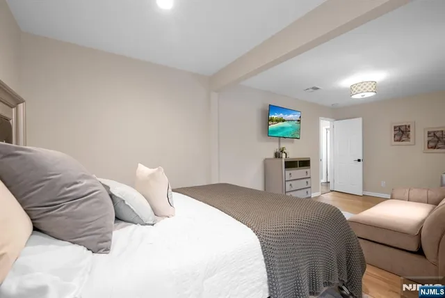 a bedroom with a bed and a couch