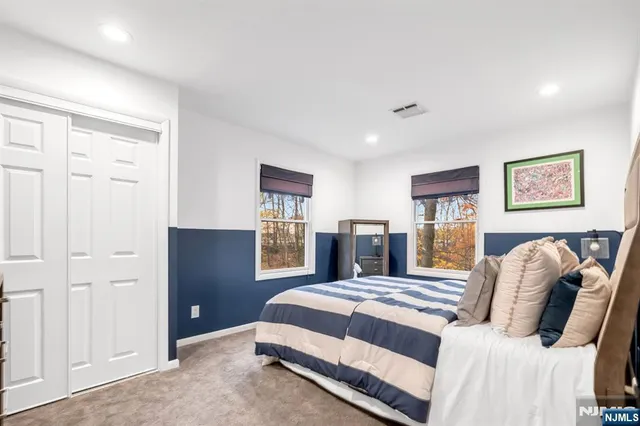 a bedroom with a large bed and a window