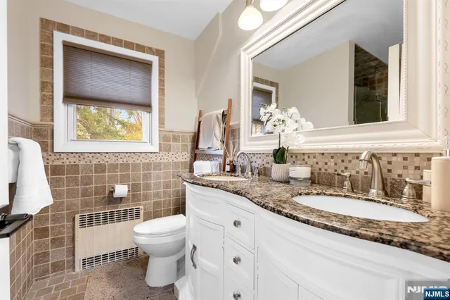 a bathroom with a toilet sink and mirror