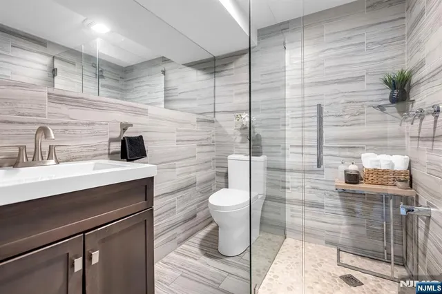 a bathroom with a sink toilet and shower
