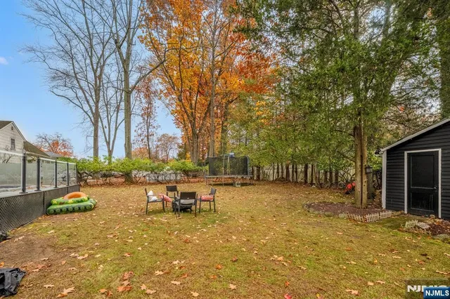 a view of a patio with table and chairs with wooden fence and floor
