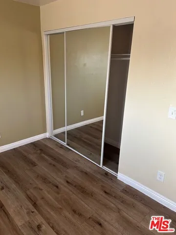 a bed sitting in a bedroom next to a window with potted plant