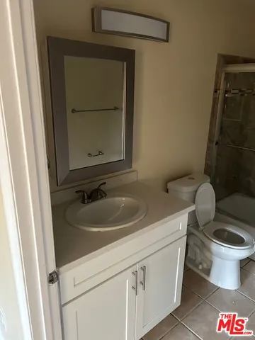 an empty room with wooden floor and entrance