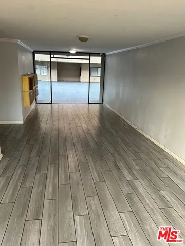 a room with wooden floor and staircase