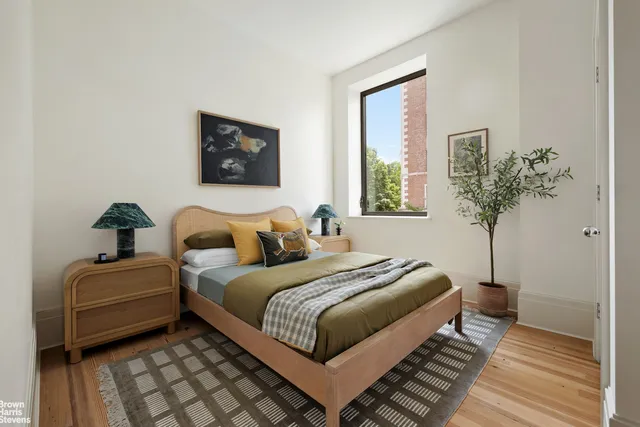 a bedroom with furniture and a window