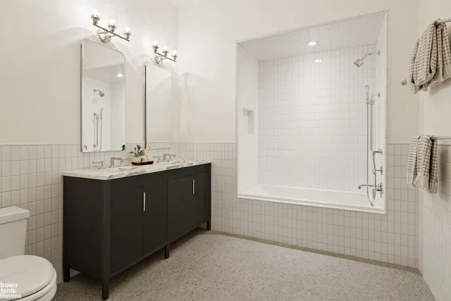 a bedroom with bed and a potted plant