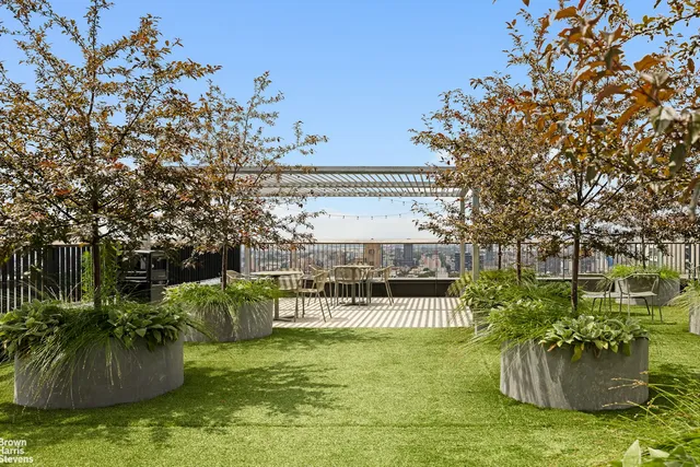 a view of a roof deck with couches and chairs