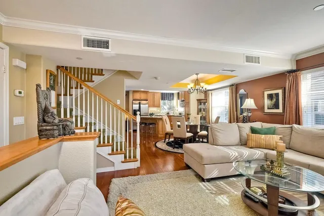 a view of a dining room with furniture wooden floor and chandelier