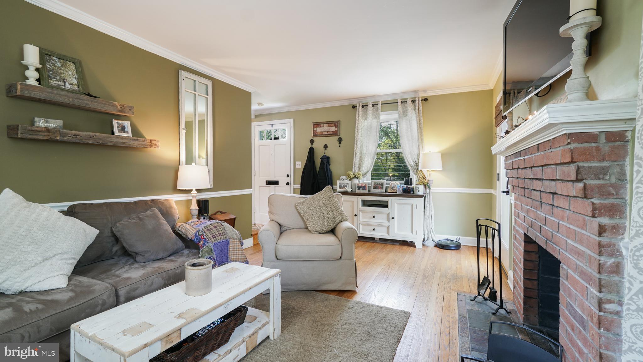 2709 Byron Street Silver Spring, MD 20902 - Photo 7 of 21 Living room w/ wood fireplace, chair rail moldings