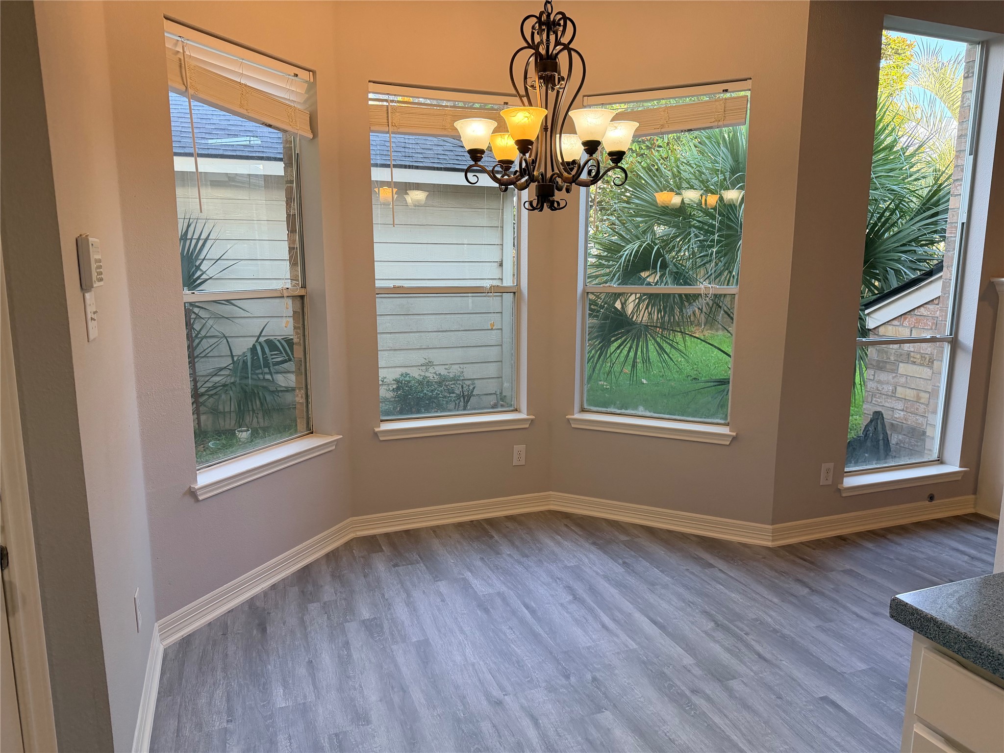 2303 Chelsea Ridge Court Katy, TX 77450 - Photo 6 of 12 a view of a livingroom with wooden floor a chandelier and windows