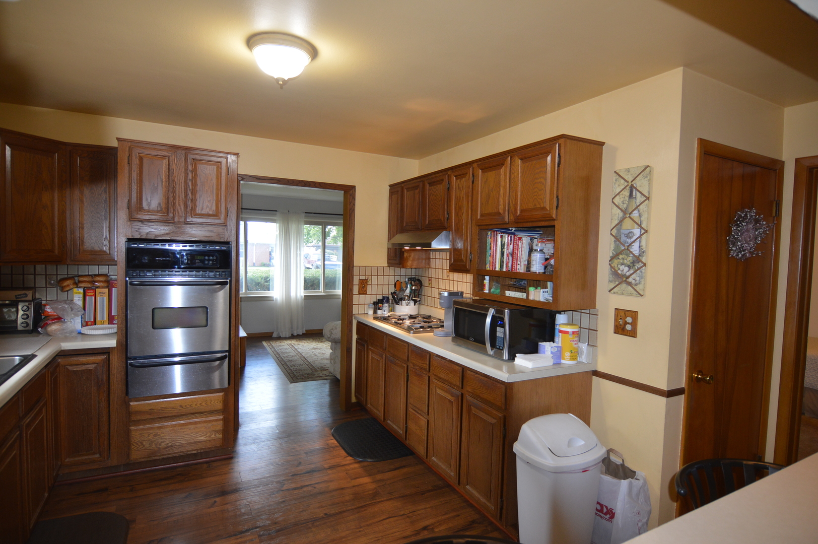 414 Brown Street Wauconda, IL 60084 - Photo 4 of 29 a kitchen with granite countertop a refrigerator stove and wooden cabinets