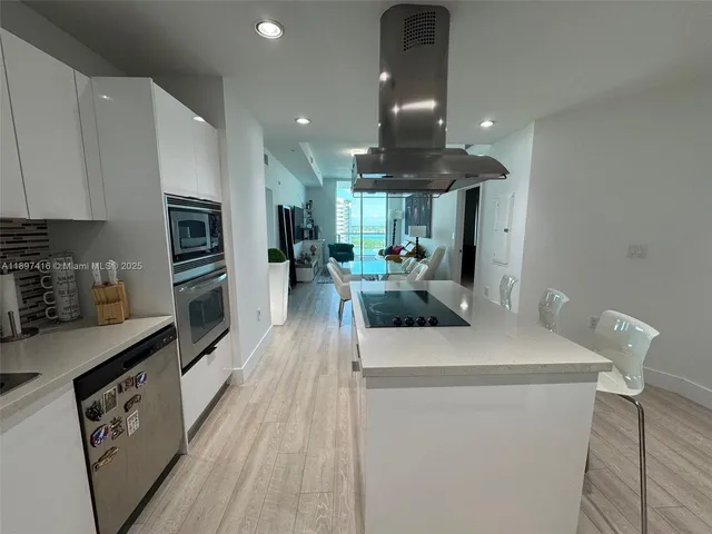 a kitchen with sink a stove and refrigerator