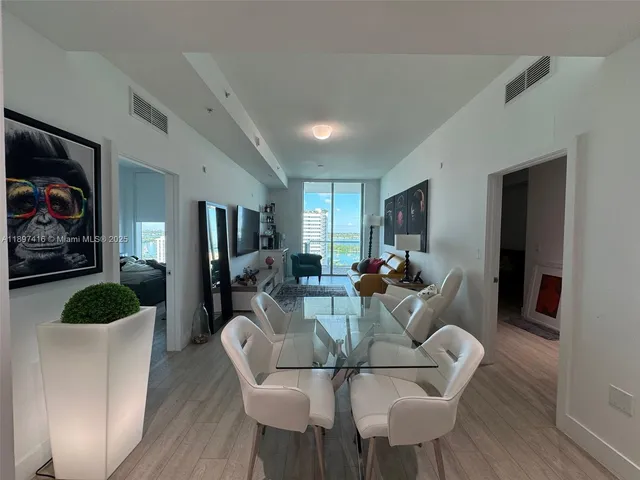 a living room with furniture dining room and wooden floor