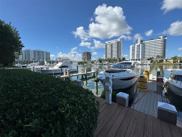 a view of a roof deck with table and chairs couches with wooden floor
