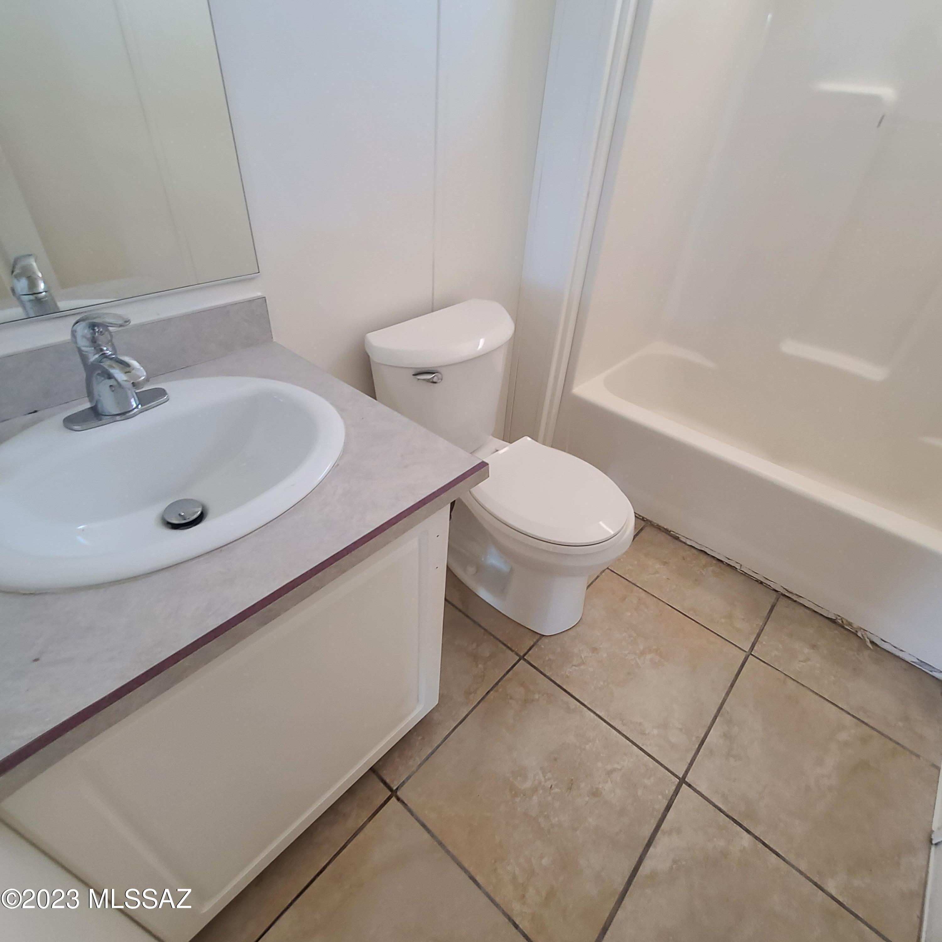 8896 South Marstellar Road Tucson, AZ 85736 - Photo 17 of 39 a bathroom with a sink a toilet and shower