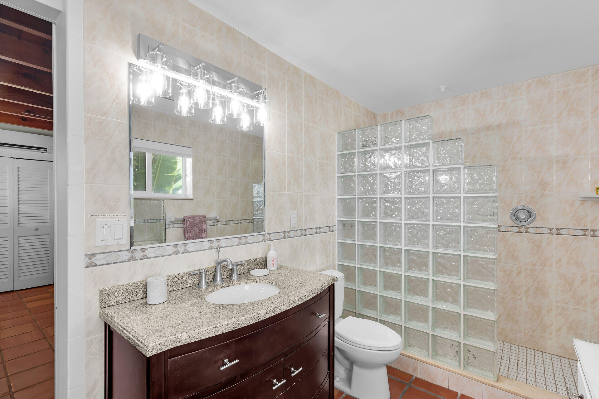 351 5th Street Key Colony Beach, FL 33051 - Photo 29 of 43 a bathroom with a granite countertop sink a toilet a mirror and shower