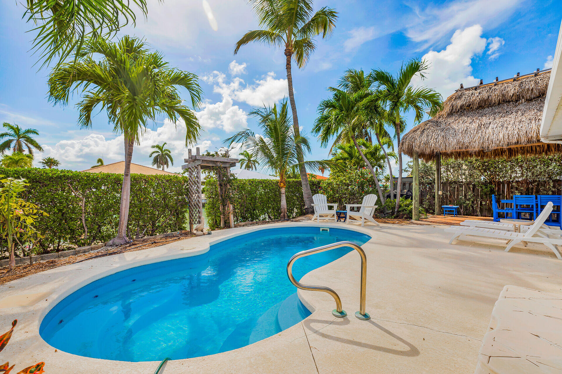 351 5th Street Key Colony Beach, FL 33051 - Photo 35 of 43 a view of a swimming pool with a garden and patio