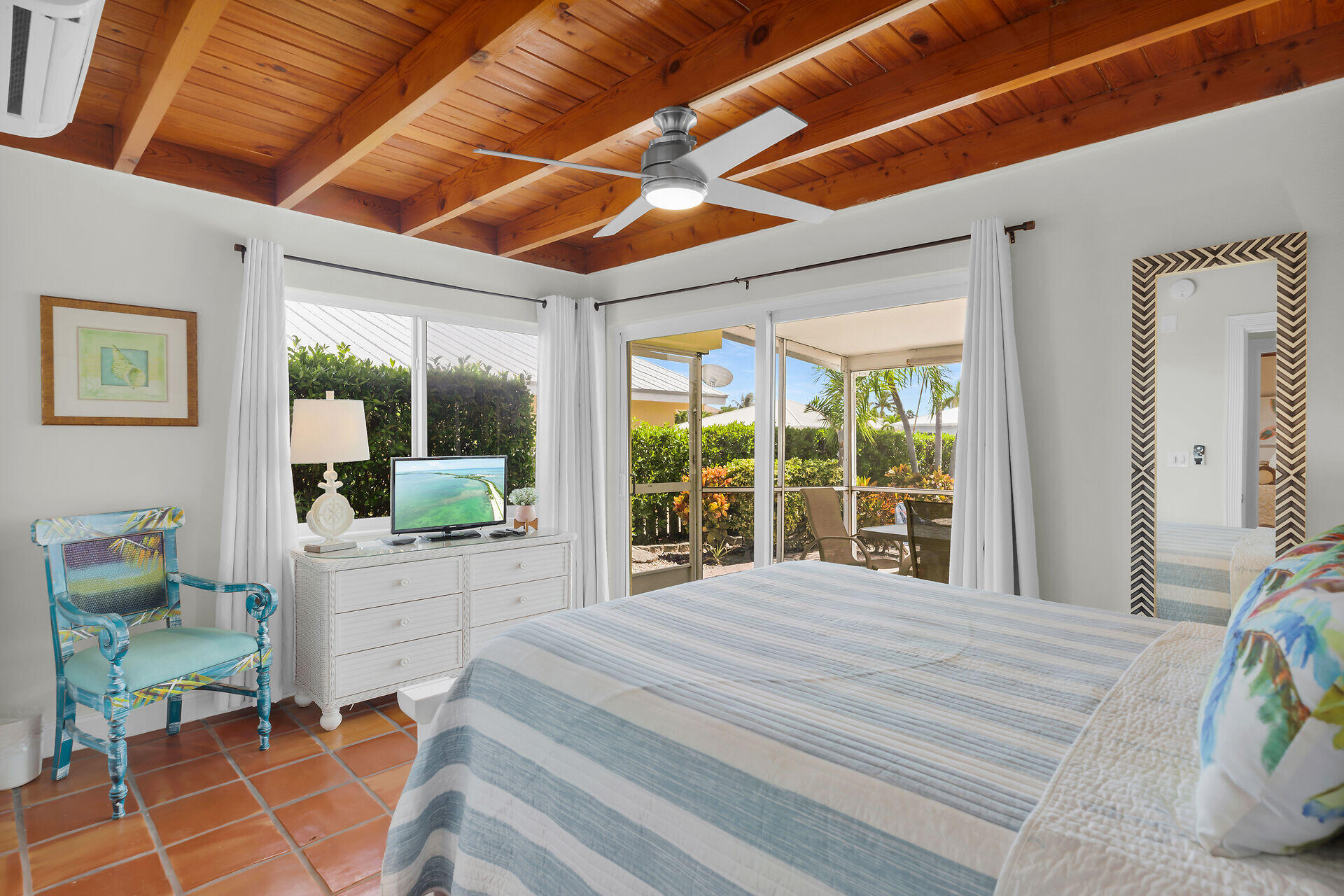 351 5th Street Key Colony Beach, FL 33051 - Photo 7 of 43 a bedroom with a bed and glass door