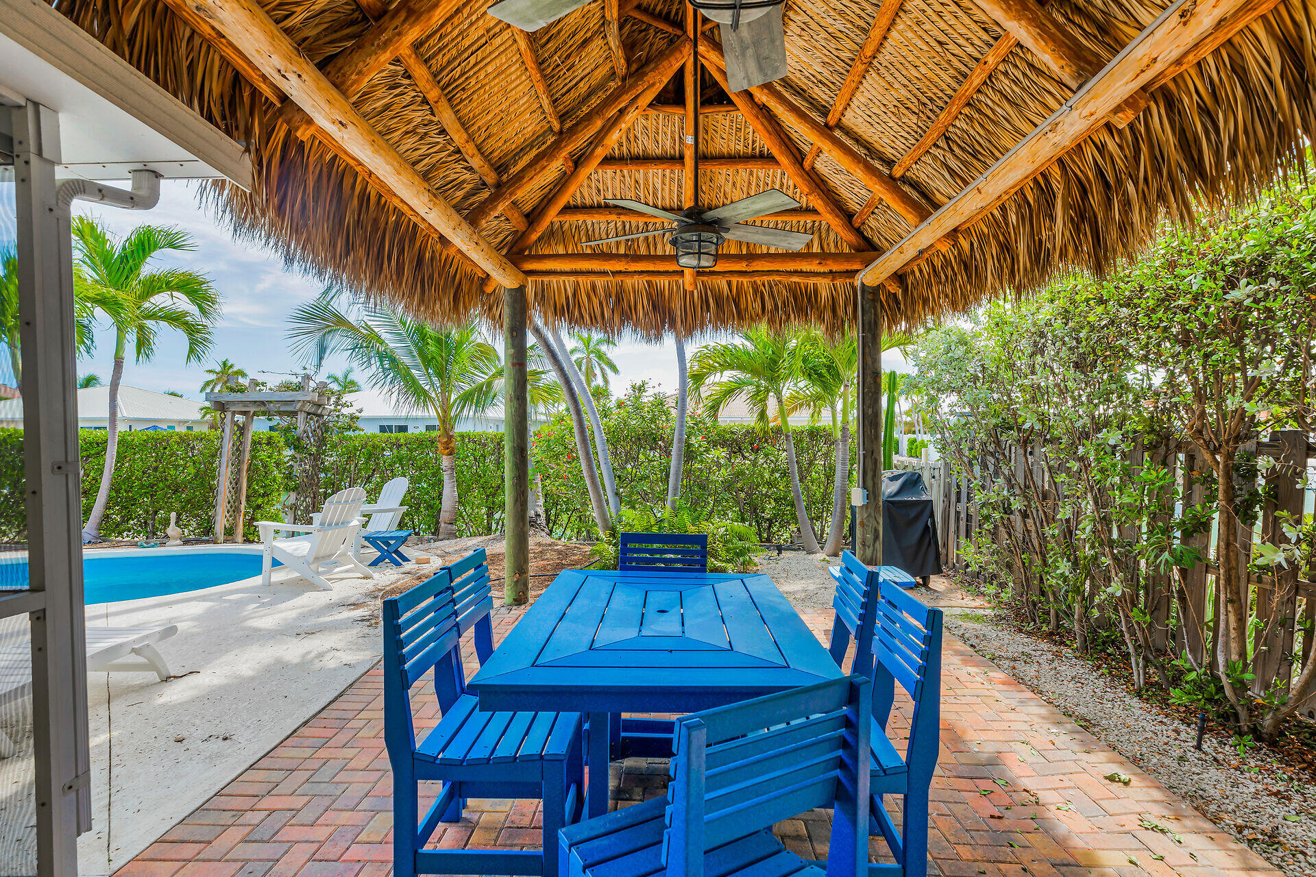 351 5th Street Key Colony Beach, FL 33051 - Photo 9 of 43 a view of a table and chairs in patio with a backyard