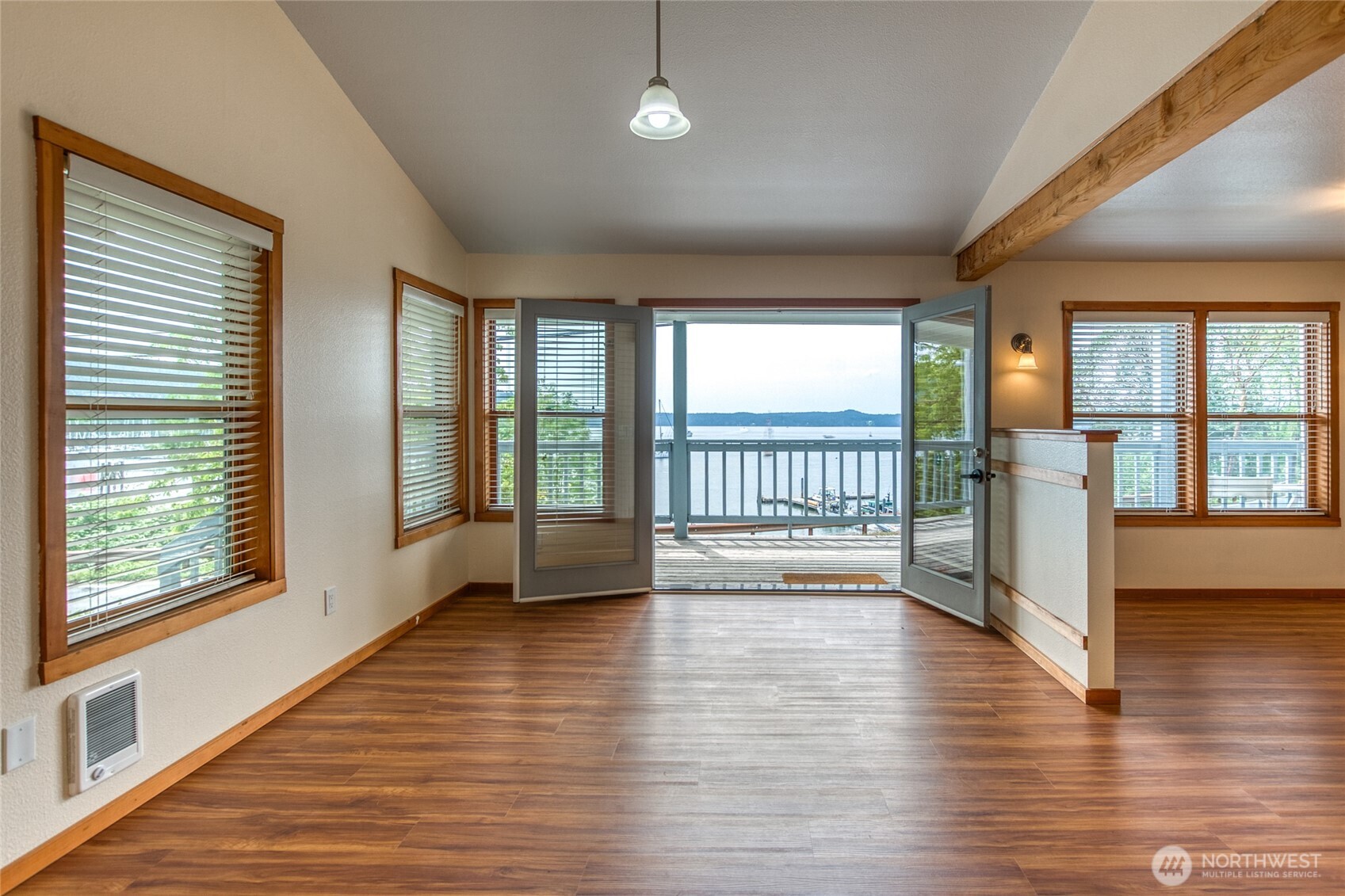 942 Deer Harbor Road Orcas Island, WA 98245 - Photo 4 of 40 an empty room with wooden floor and windows